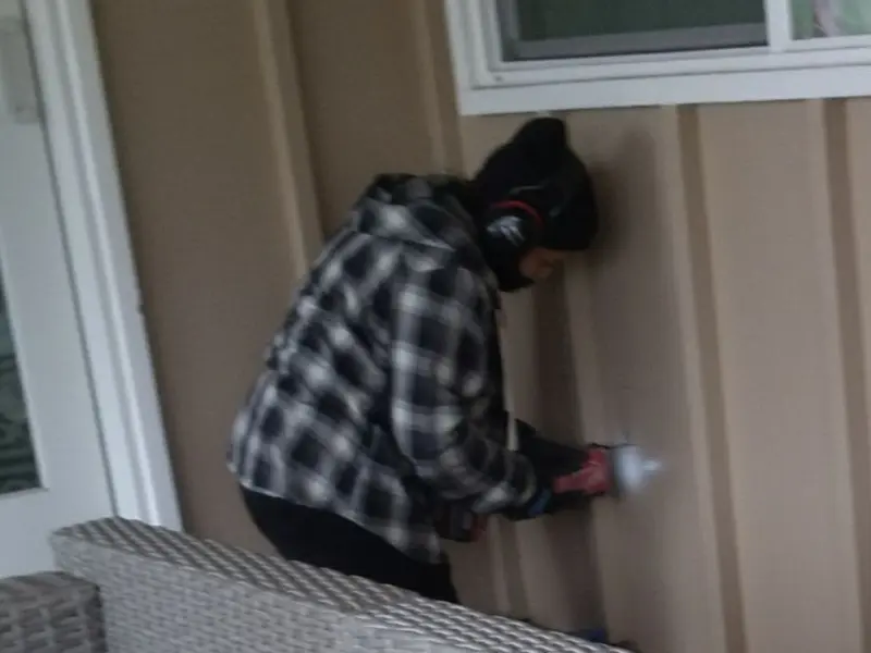 Professional electrician installing an exterior outlet in Central City